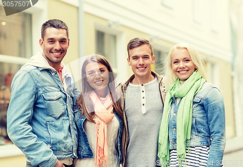 Image of group of smiling friends in city