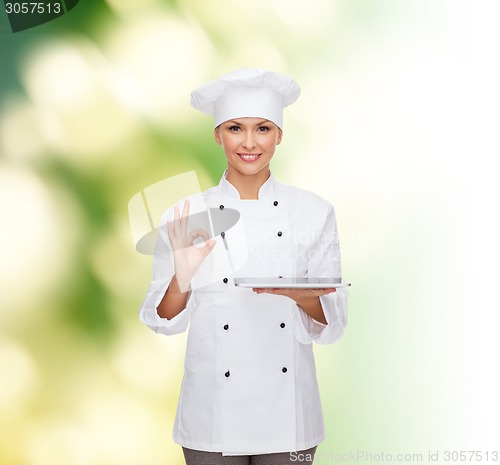 Image of smiling female chef with tablet pc computer
