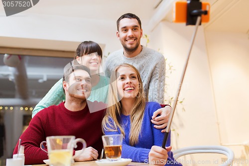 Image of group of friends taking selfie with smartphone