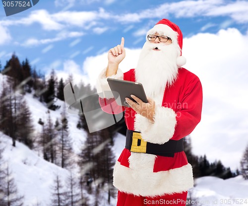 Image of man in costume of santa claus with tablet pc