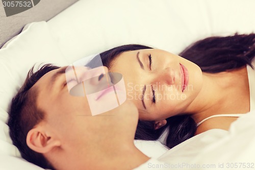 Image of happy couple sleeping in bed