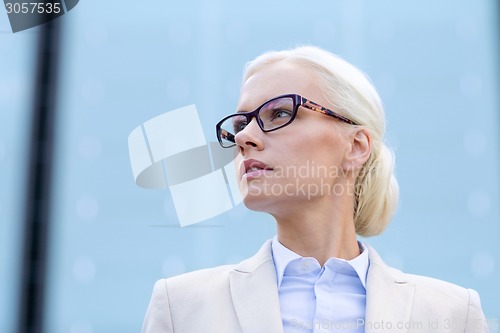 Image of young businesswoman over office building