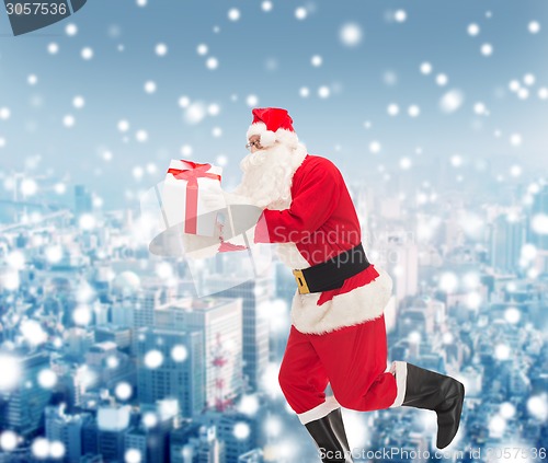 Image of man in costume of santa claus with gift box