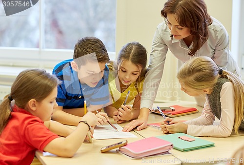 Image of group of school kids writing test in classroom