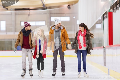 Image of happy friends on skating rink