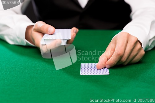 Image of holdem dealer with playing cards