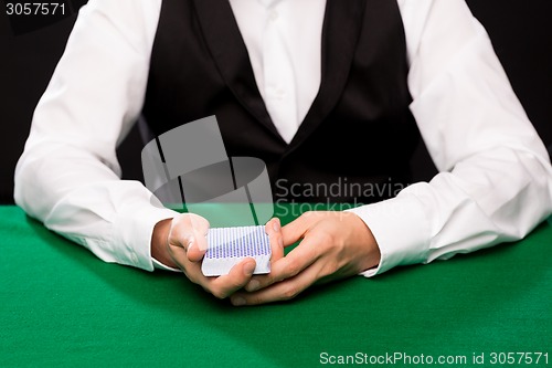 Image of holdem dealer with playing cards