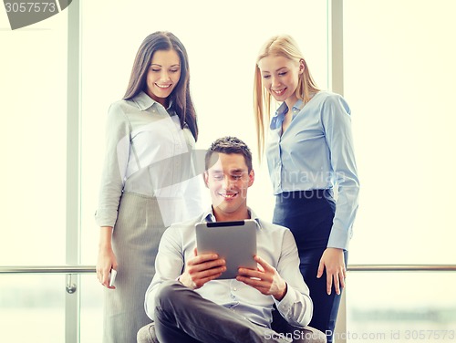 Image of business team working with tablet pc in office