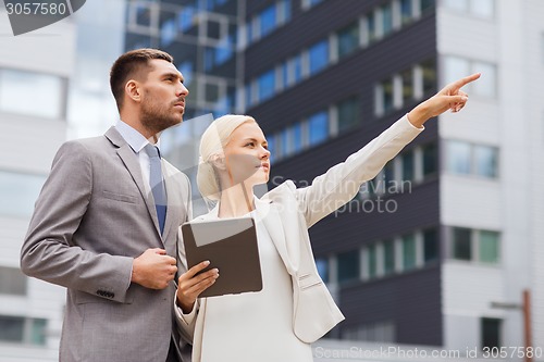 Image of serious businessmen with tablet pc outdoors