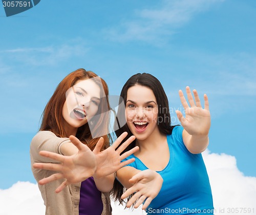 Image of smiling teenage girls having fun