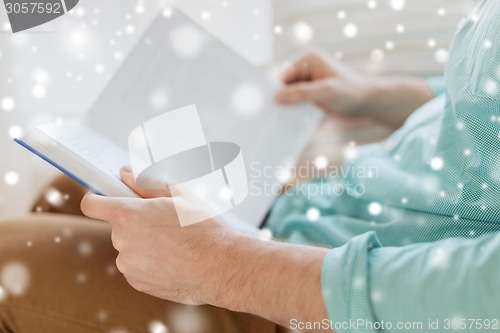 Image of close up of man reading book at home