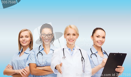 Image of smiling female doctor and nurses with stethoscope