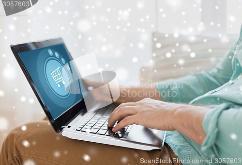 Image of close up of man working with laptop at home