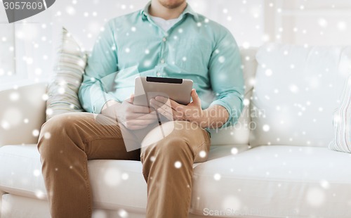 Image of close up of man with tablet pc computer at home