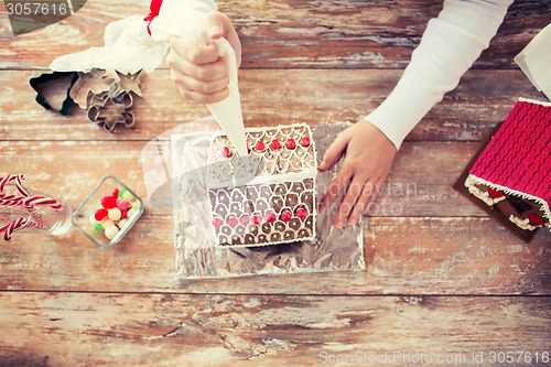 Image of close up of woman making gingerbread houses