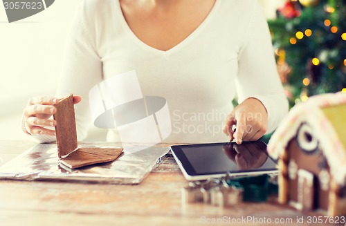 Image of close up of woman making gingerbread houses