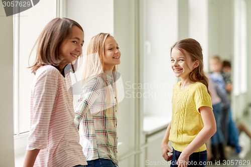 Image of group of smiling school kids in corridor