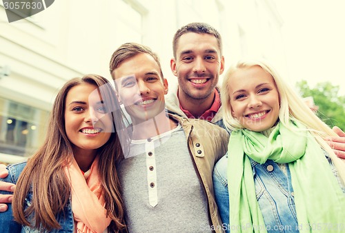 Image of group of smiling friends in city