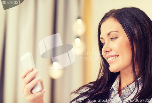 Image of happy businesswoman with smartphone in hotel room