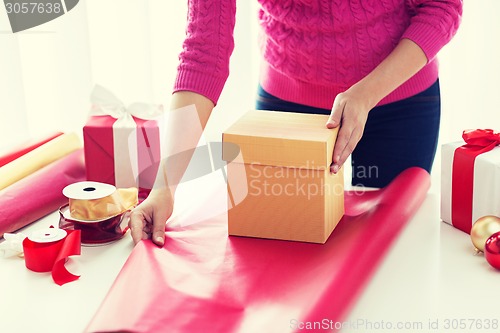 Image of close up of woman decorating christmas presents