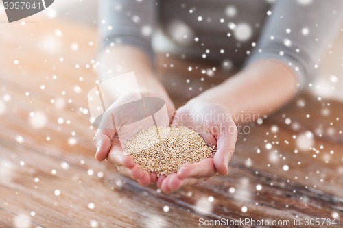 Image of close up of female cupped hands with quinoa