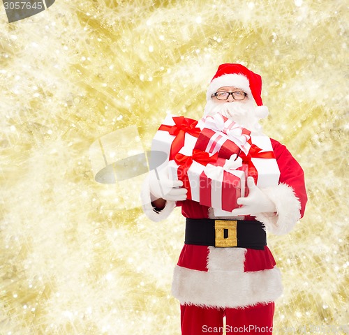 Image of man in costume of santa claus with gift boxes