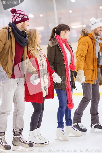 Image of happy friends on skating rink