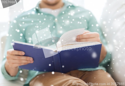 Image of close up of man reading book at home