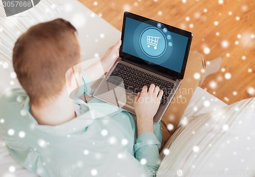 Image of close up of man working with laptop at home