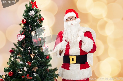 Image of santa claus with bag and christmas tree