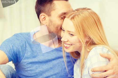 Image of smiling happy couple at home