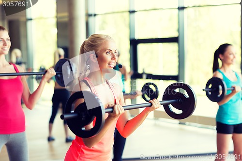 Image of group of women with barbells in gym