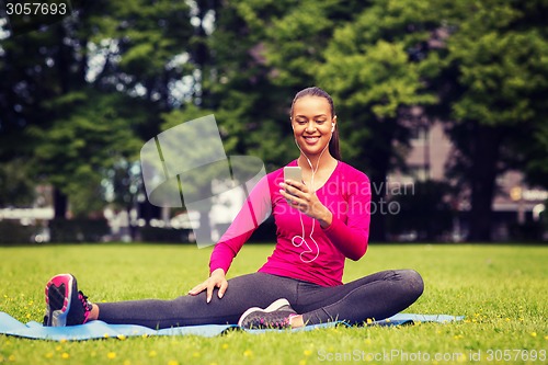 Image of smiling african american woman with smartphone