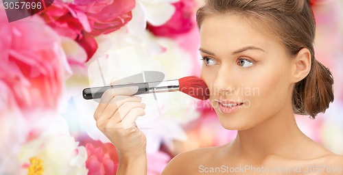 Image of beautiful smiling woman with make up brush