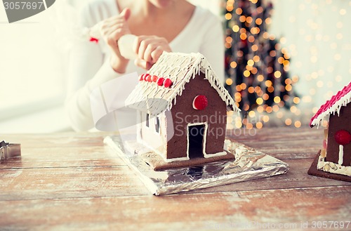 Image of close up of woman making gingerbread houses