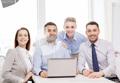 Image of business team working with laptop in office