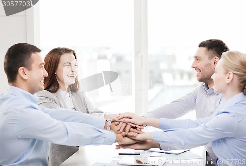 Image of business team celebrating victory in office