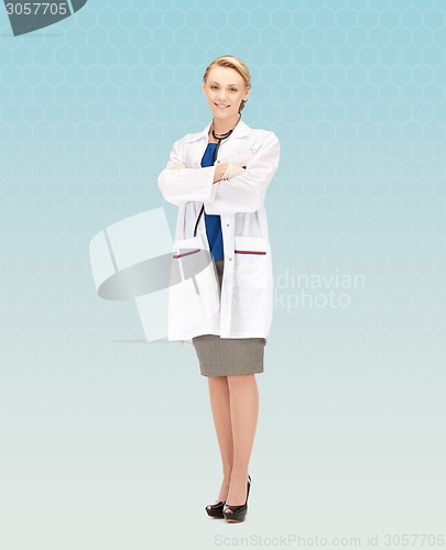 Image of smiling young female doctor in white coat