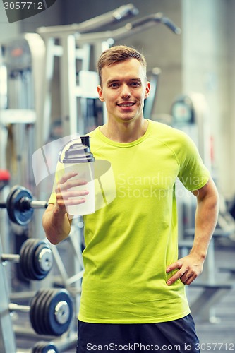 Image of smiling man with protein shake bottle