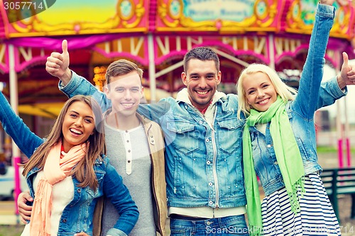 Image of group of smiling friends showing thumbs up