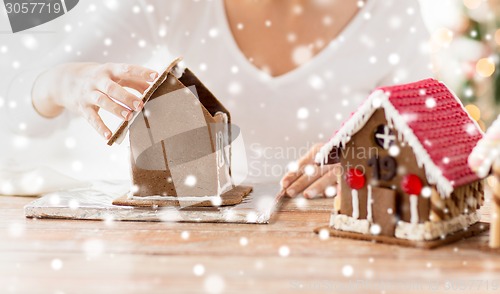 Image of close up of woman making gingerbread houses