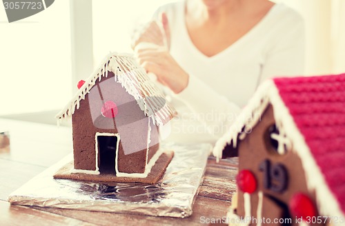 Image of close up of woman making gingerbread houses