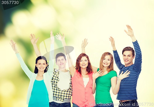 Image of group of smiling students waving hands