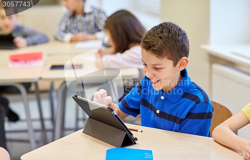 Image of school kids with tablet pc in classroom