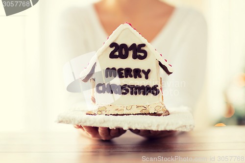 Image of close up of woman showing gingerbread house