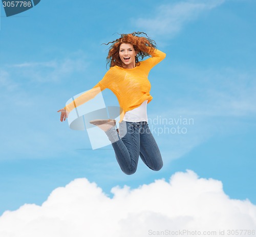 Image of smiling young woman jumping in air