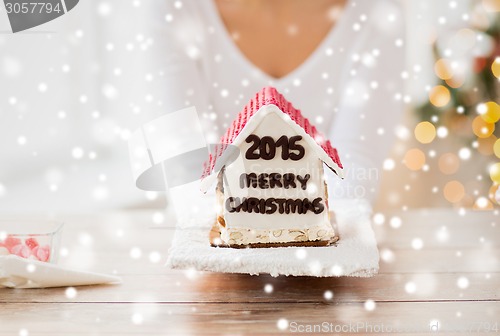 Image of close up of woman showing gingerbread house