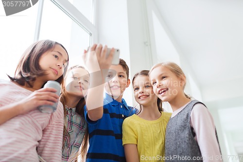 Image of group of school kids with smartphone and soda cans