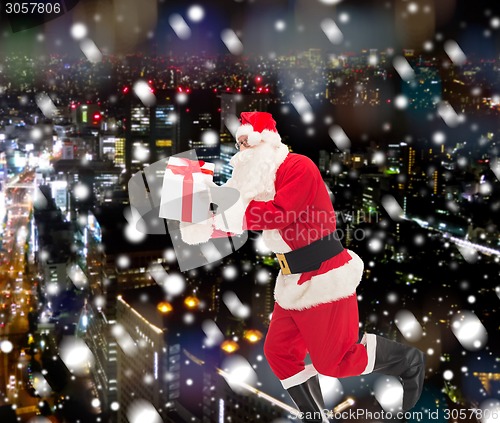 Image of man in costume of santa claus with gift box