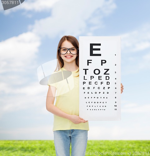 Image of little girl in eyeglasses with eye checking chart